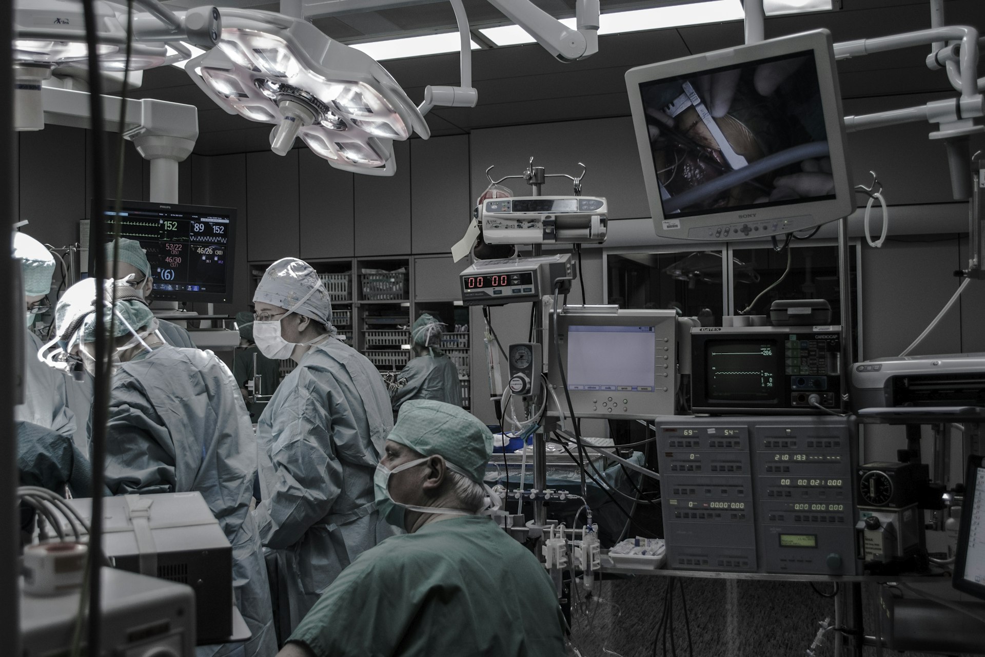 A wide view of an operating theatre with clinicians and monitors