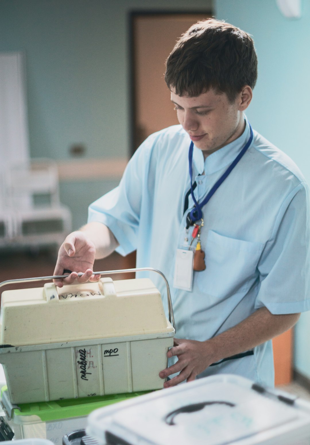 A young physician in medical uniform carrying a case
